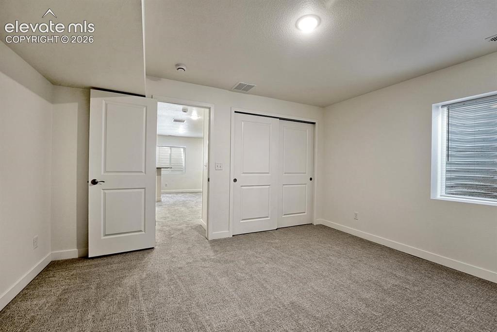 Image 40 of 50: Basement bedroom