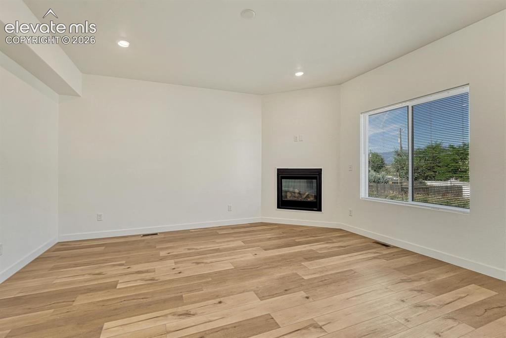 Image 6 of 50: Living room features a gas fireplace and durable LVP flooring