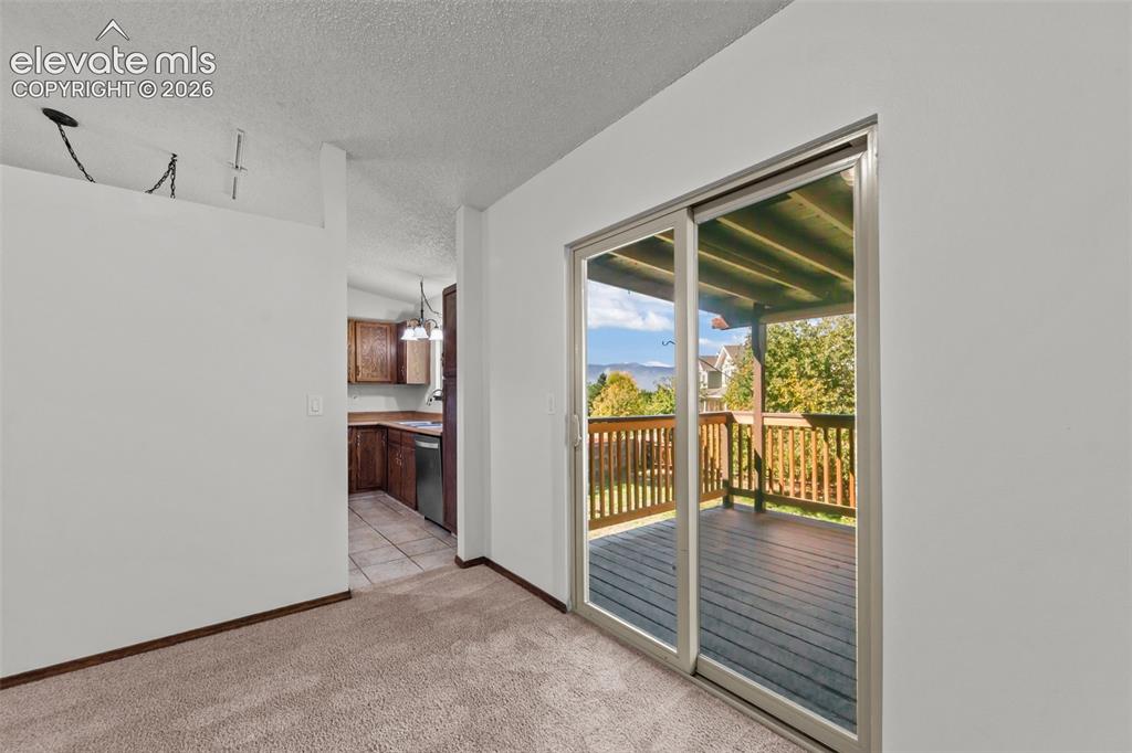 Image 4 of 22: Walks out to nice wood deck with stunning views