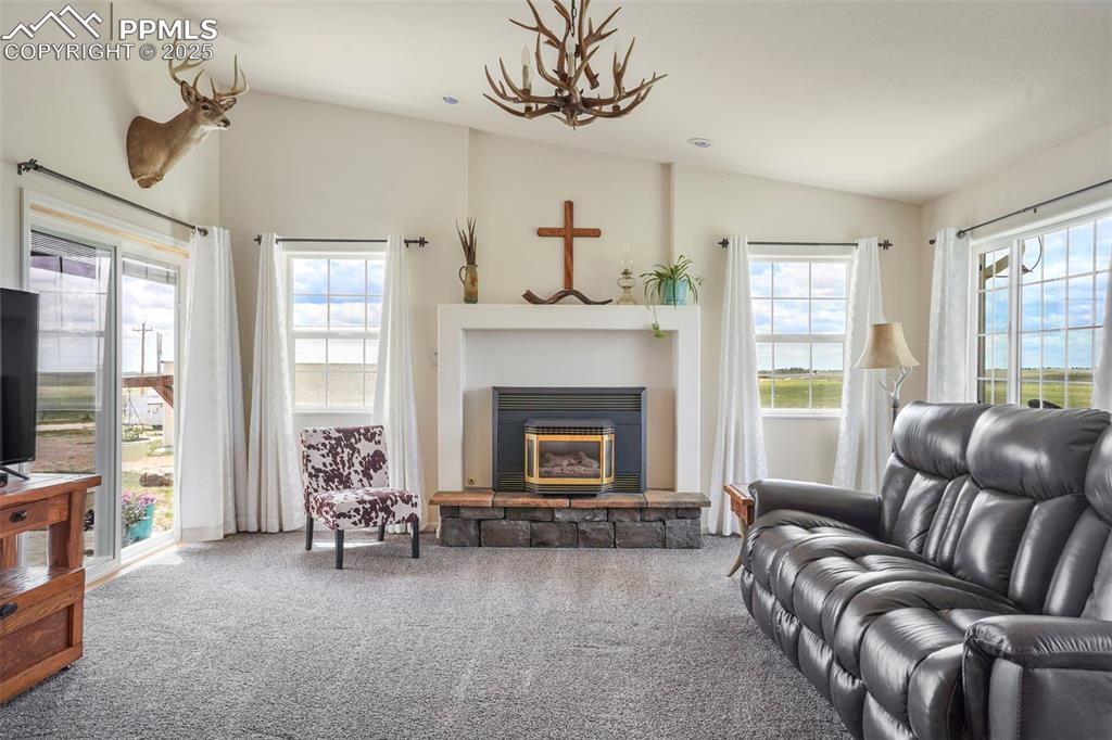 Image 10 of 50: Living room with walk out to the front porch and walk out to the deck.