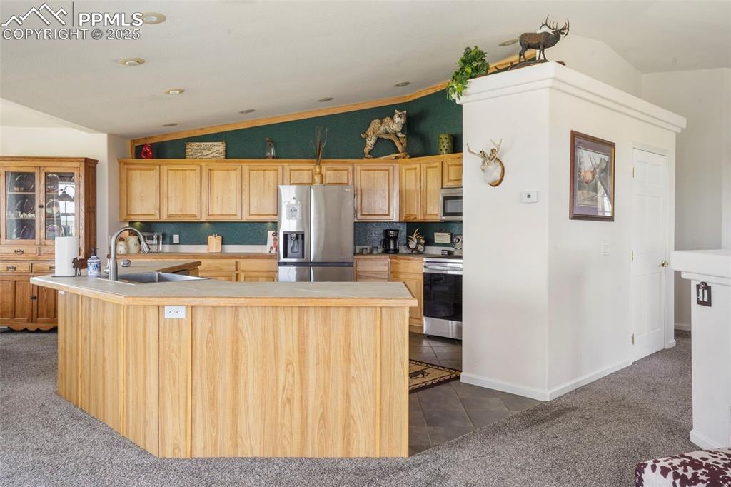 Image 14 of 50: Kitchen that is the heart of the home. Open to the dining and living area.