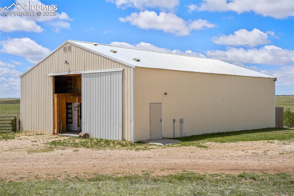 Image 6 of 50: The 60X40 barn/workshop has a brand-new roof and two stalls with mats and a