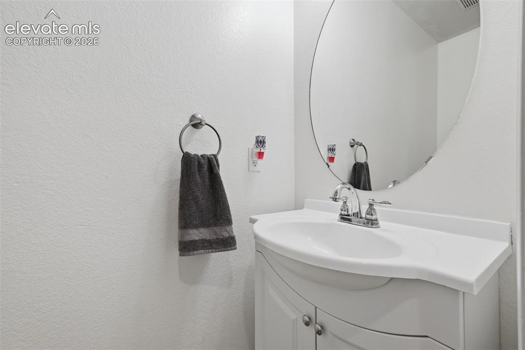 Image 17 of 35: White vanity with an integrated sink and chrome faucet
