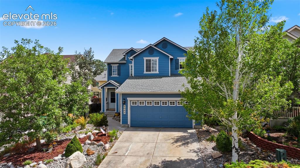 Image 2 of 35: Two-story residence featuring blue siding, white trim, a gray shingled roof