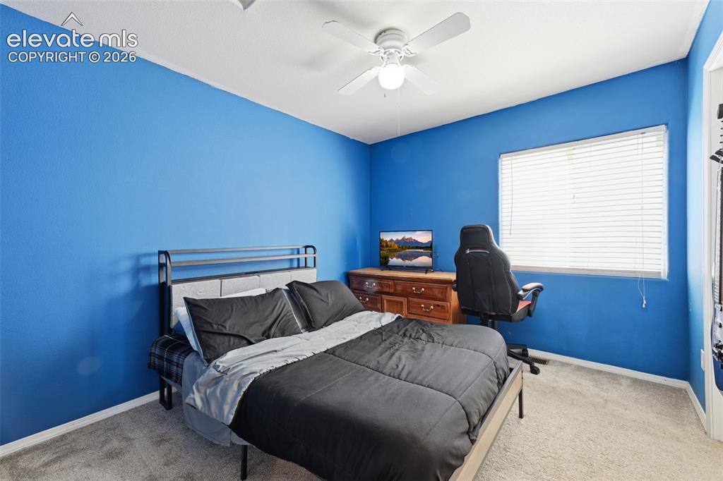 Image 24 of 35: Carpeted room featuring a ceiling fan with integrated lighting, a window wi