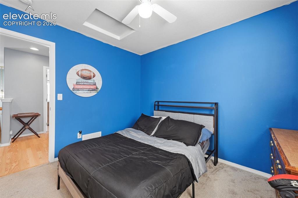 Image 25 of 35: Recessed ceiling light, ceiling fan with light, and carpeted flooring
