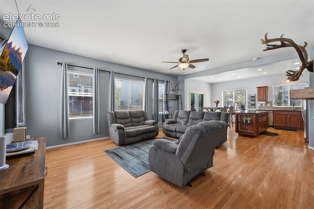 Image 8 of 35: Hardwood flooring throughout, recessed lighting, and a ceiling fan