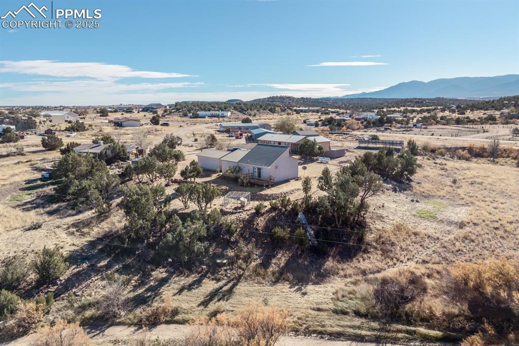Image 11 of 50: Overview of rural landscape featuring a mountainous background and a desert