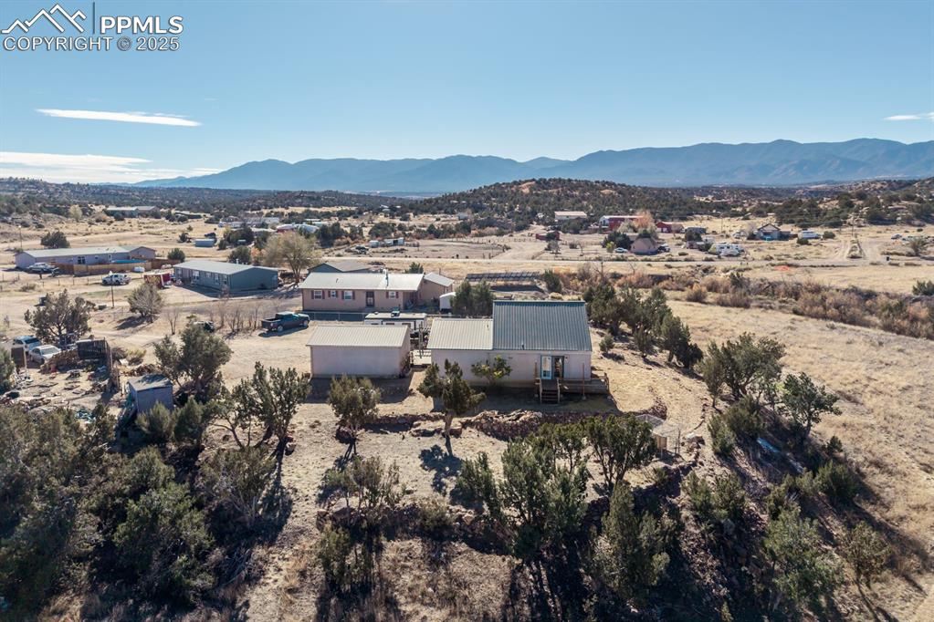 Image 16 of 50: Aerial view of property and surrounding area featuring a mountain backdrop