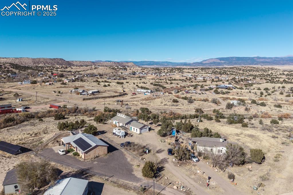 Image 21 of 50: Overview of rural landscape with a mountain backdrop and a desert landscape