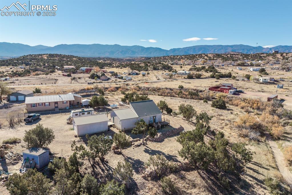 Image 22 of 50: View of rural area with a mountain backdrop