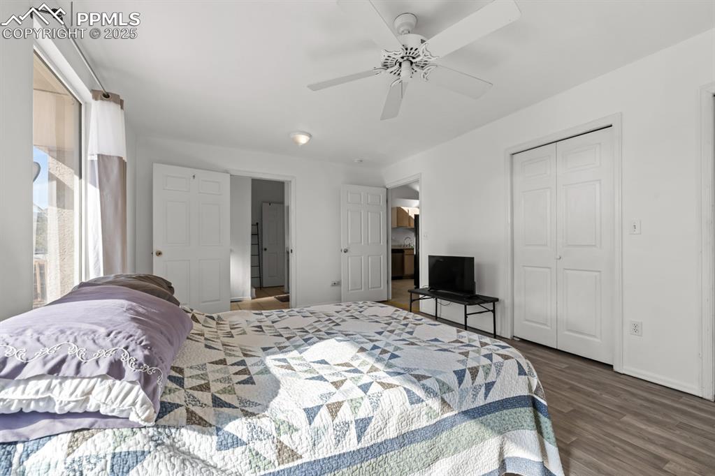 Image 42 of 50: Bedroom featuring dark wood-style floors, ceiling fan, and a closet