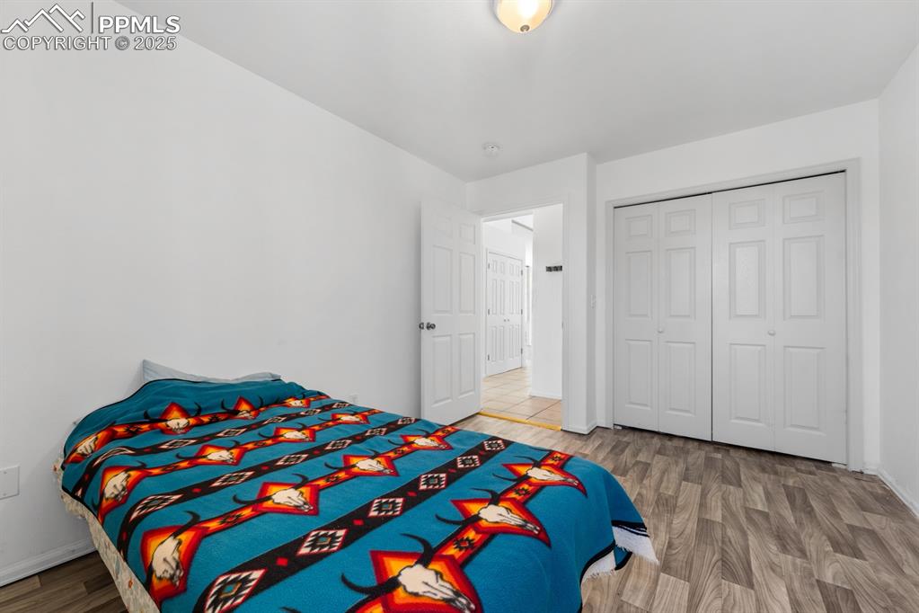 Image 47 of 50: Bedroom featuring wood finished floors and a closet
