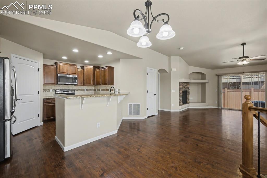 Image 10 of 42: The kitchen features a beautiful backsplash and countertops, and walk-in pa