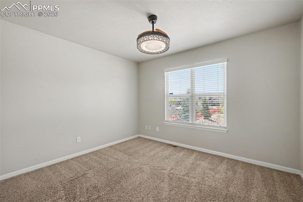 Image 25 of 42: A bedroom in addition to the primary bedroom is also located on the main le