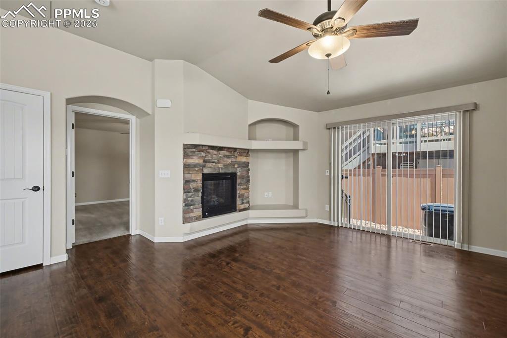 Image 3 of 42: The spacious living room features a fireplace to cozy up by and provides ac