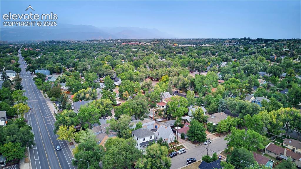 Image 10 of 50: Aerial perspective featuring a residential area with extensive tree canopy 