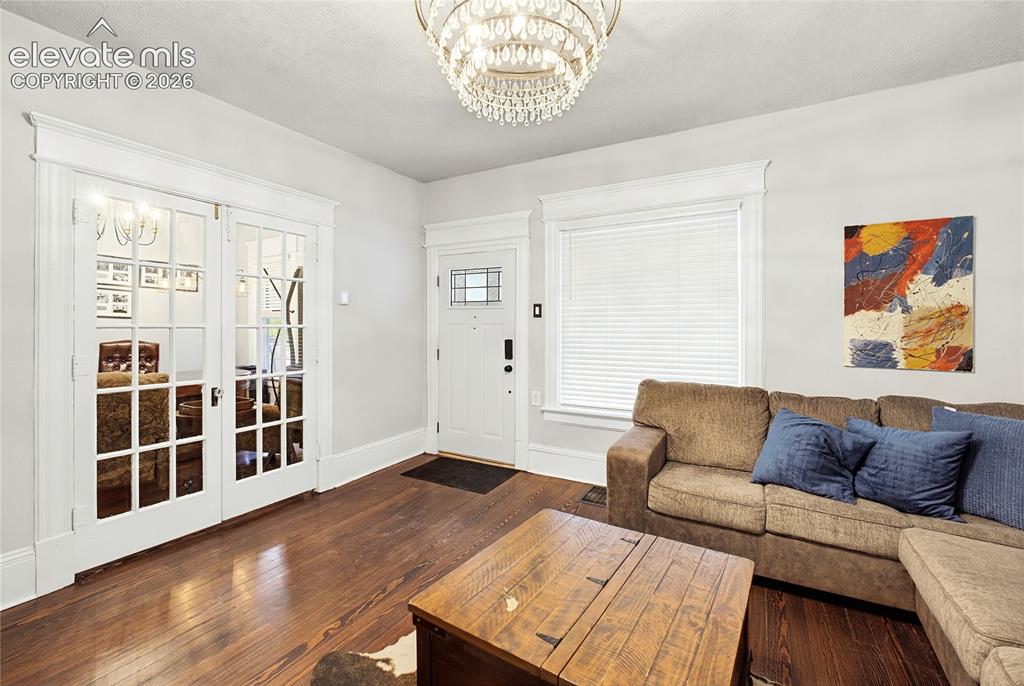 Image 14 of 50: Hardwood flooring, crystal chandelier, double French doors, front entry doo