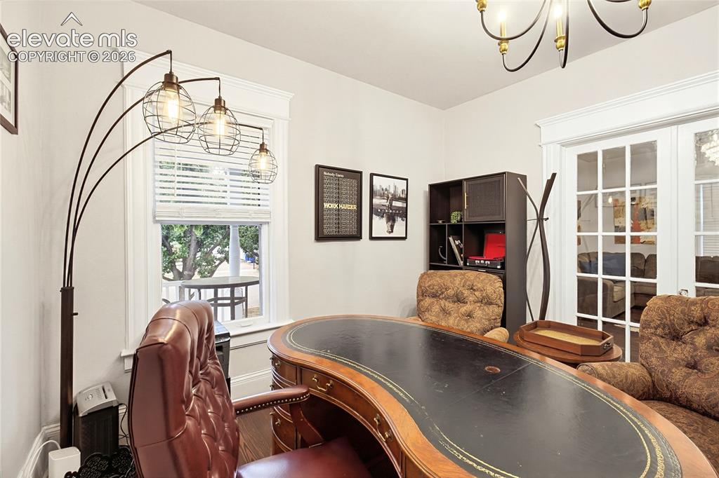 Image 20 of 50: Interior room with a large window, white window blinds, and white trim