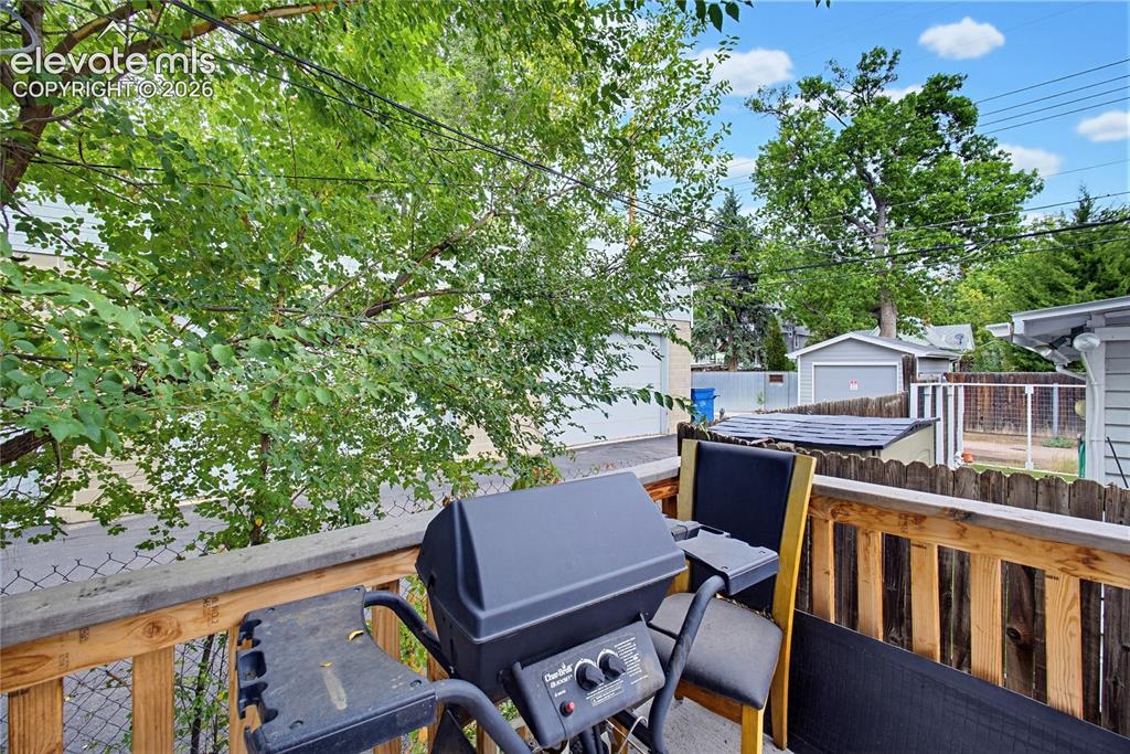 Image 29 of 50: Outdoor wooden deck with slatted railing