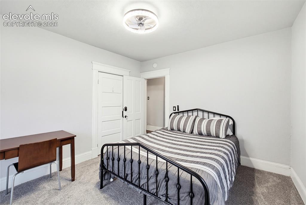 Image 32 of 50: White walls, light-toned carpet, and a ceiling-mounted light fixture