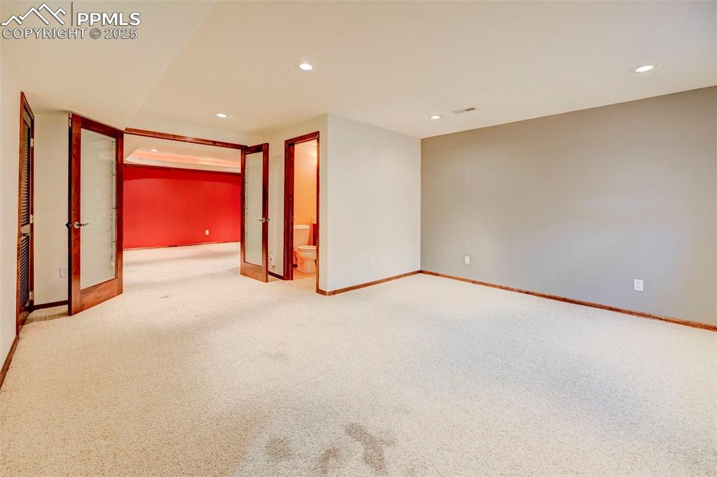 Image 15 of 34: Carpeted spare room featuring baseboards and recessed lighting