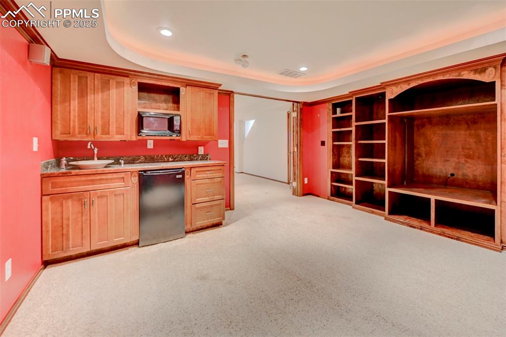 Image 18 of 34: Kitchen featuring dishwasher, open shelves, black microwave, recessed light