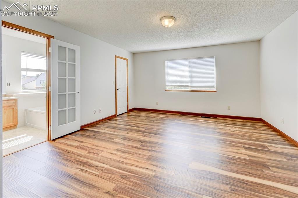 Image 22 of 34: Spare room with healthy amount of natural light, light wood-style floors, a