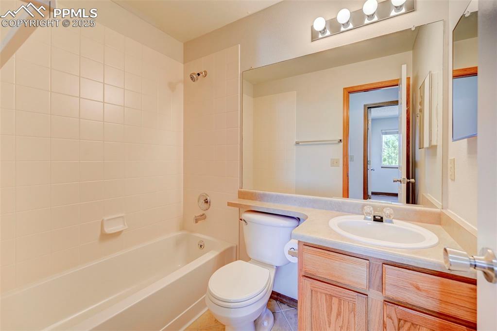 Image 28 of 34: Bathroom with vanity and tub / shower combination