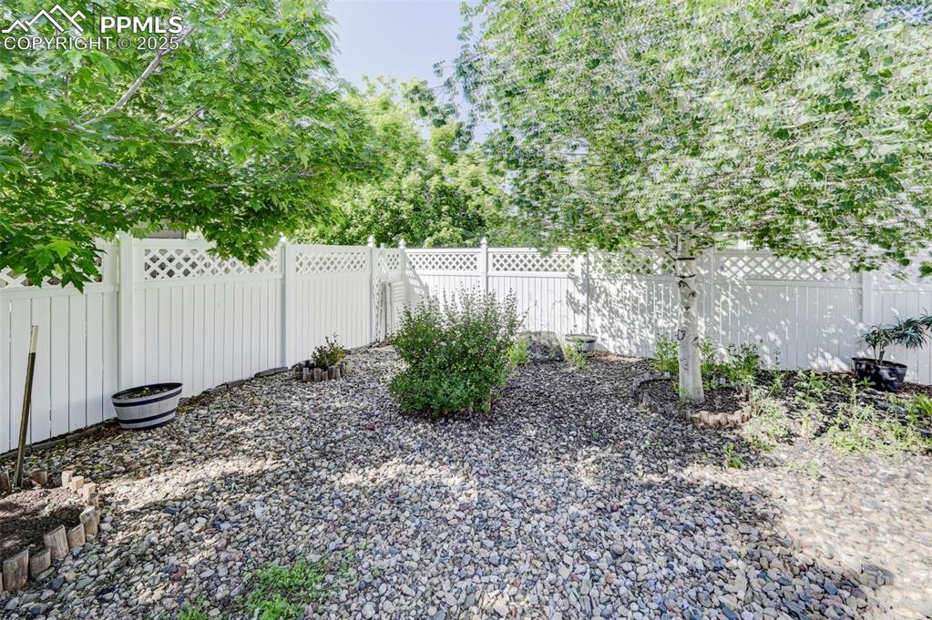 Image 32 of 34: View of fenced backyard