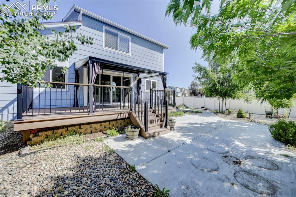 Image 33 of 34: Back of property with stairway, a patio, and a deck