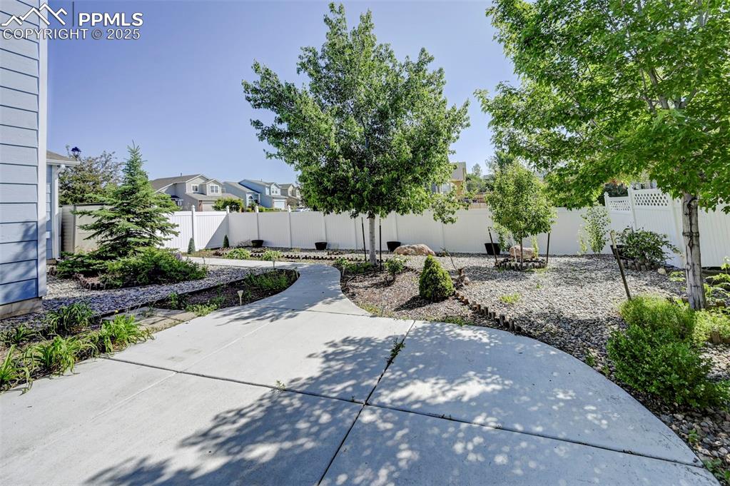 Image 34 of 34: Fenced backyard with a patio area and a residential view
