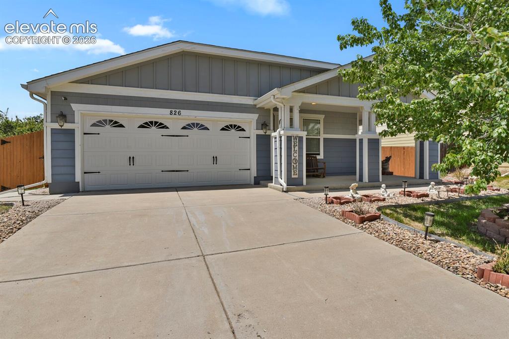 Image 1 of 31: Ranch home featuring a covered front porch, attached two-car garage with de
