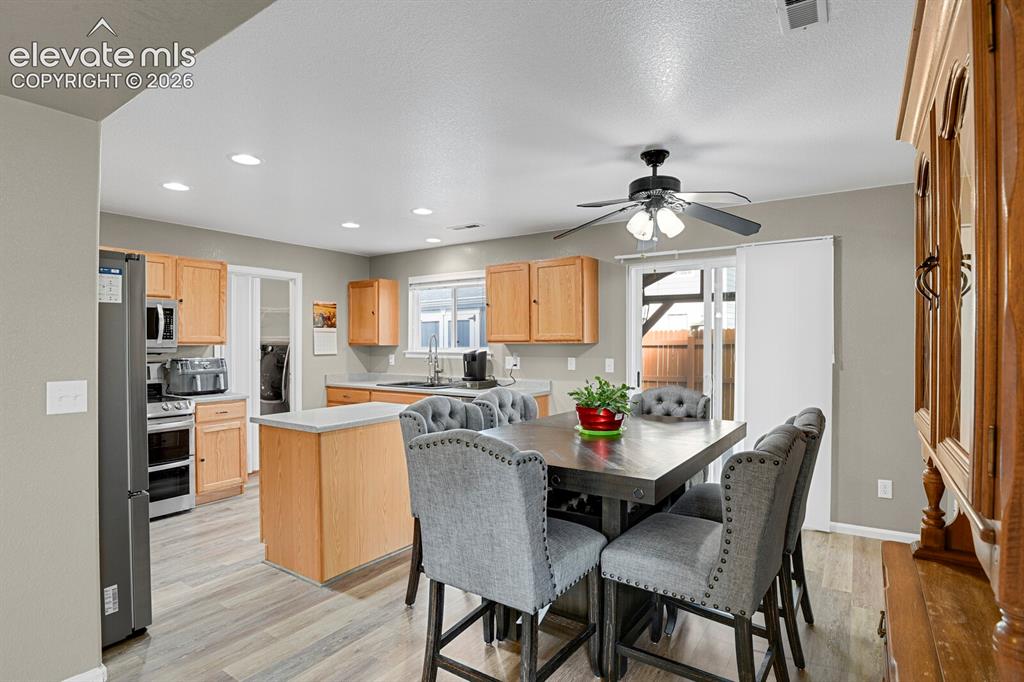 Image 11 of 31: Spacious living room featuring neutral-toned walls, gray carpeting and a ce