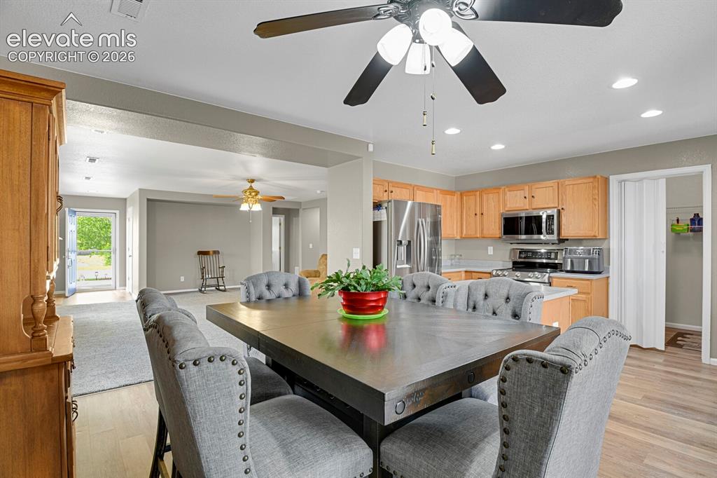 Image 12 of 31: Spacious living room featuring neutral-toned walls, gray carpeting and a ce