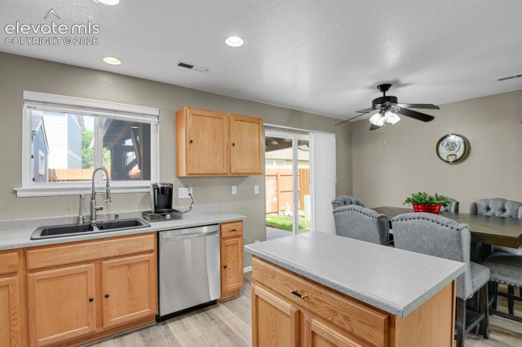 Image 14 of 31: Open-concept kitchen and dining area featuring wood- cabinetry, nice floori