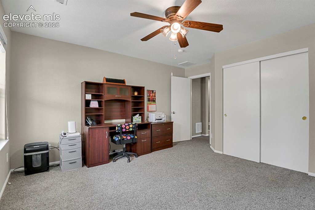 Image 18 of 31: Kitchen featuring light wood cabinetry, light grey countertops, a central i