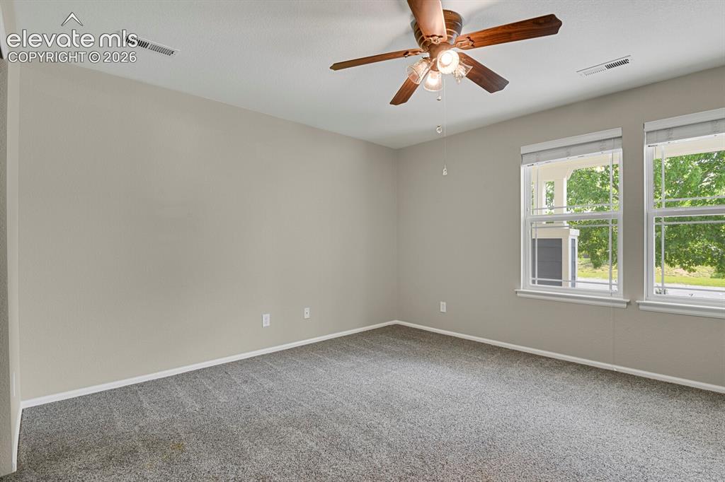 Image 19 of 31: Dedicated laundry area with built-in wire shelving and light-colored walls