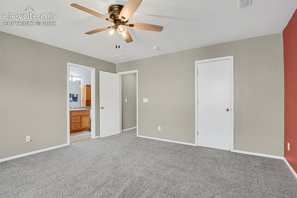 Image 24 of 31: Second bedroom featuring light blue walls, gray carpeting, a ceiling fan wi