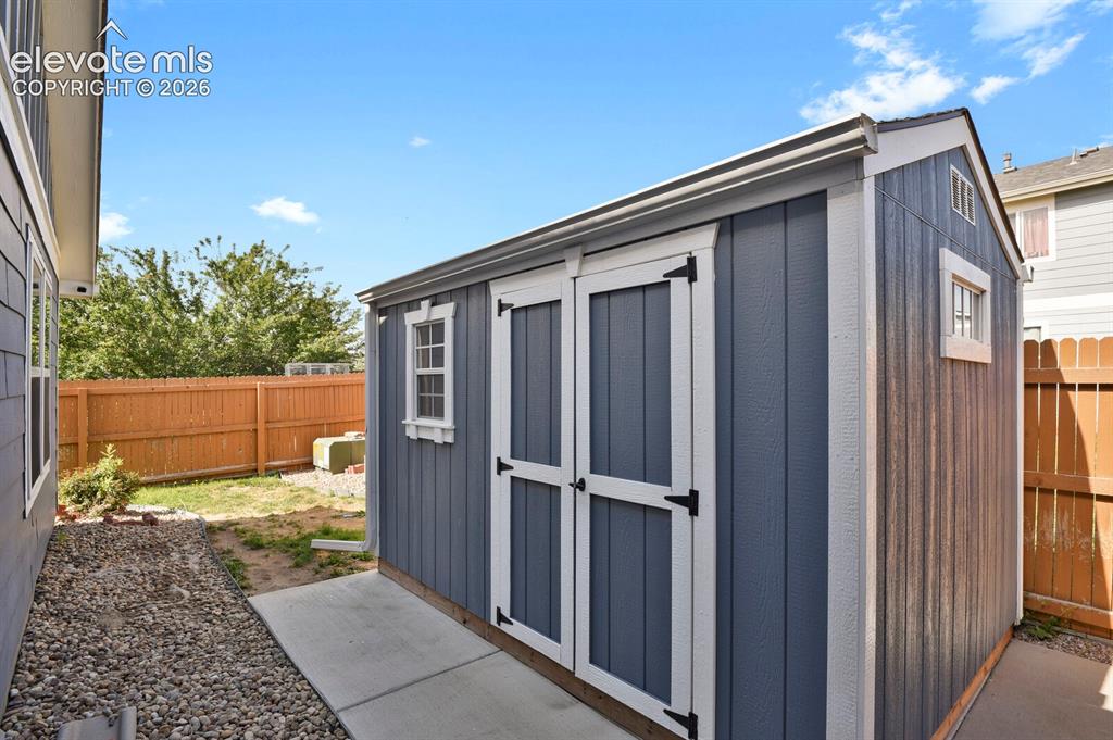 Image 28 of 31: Outdoor living area featuring a wooden gazebo with screen curtains on a nic