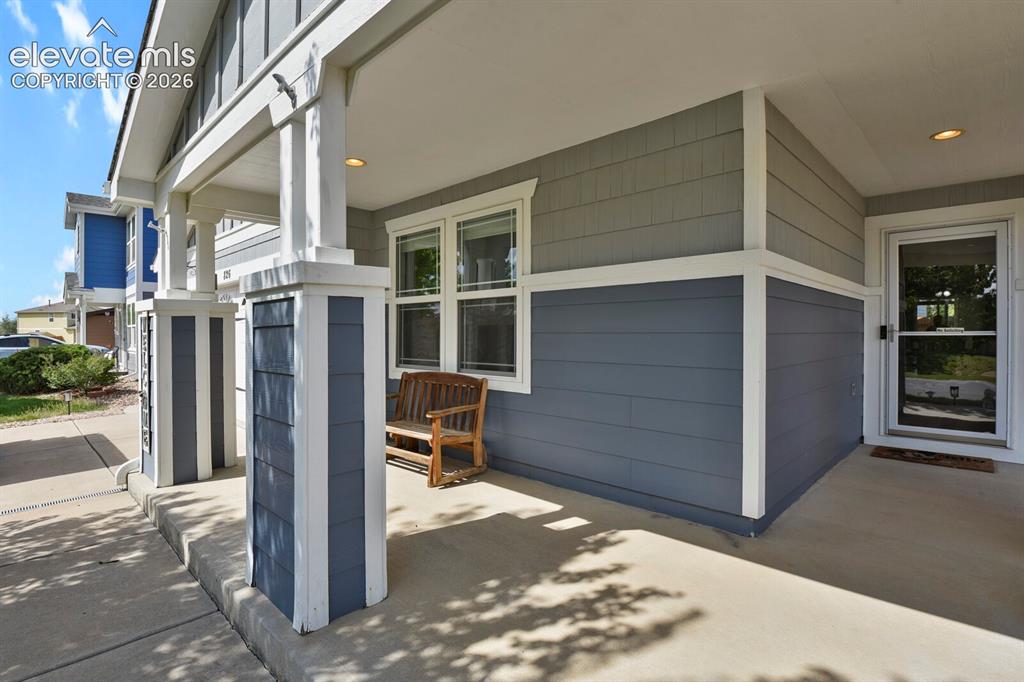Image 5 of 31: Two-car garage with arched decorative windows and carriage-style hardware