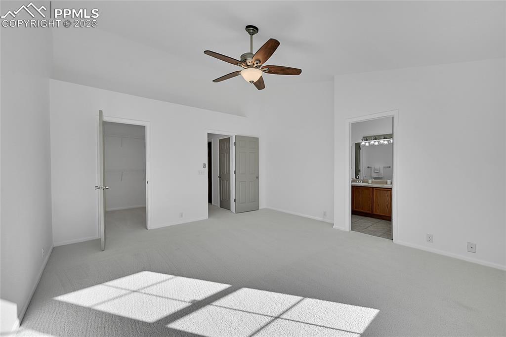 Image 18 of 31: Unfurnished bedroom featuring light colored carpet, a walk in closet, ceili