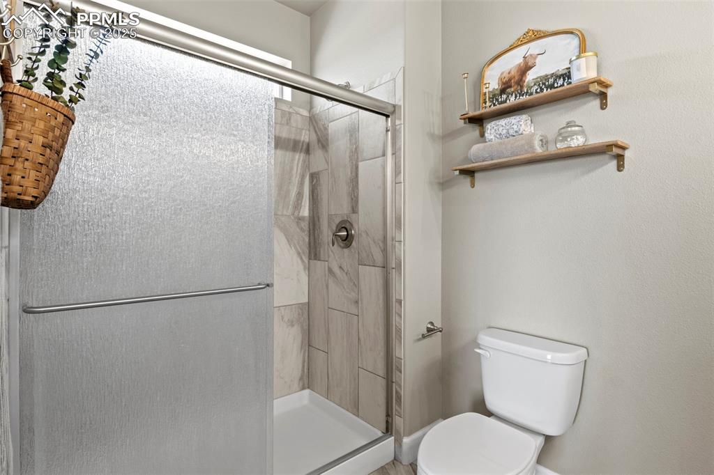 Image 29 of 30: Full bathroom with toilet and a shower stall