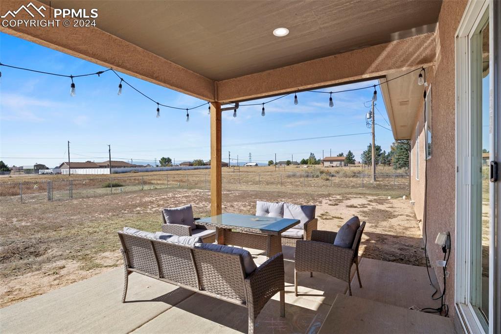 Image 30 of 30: View of patio featuring an outdoor living space and a rural view