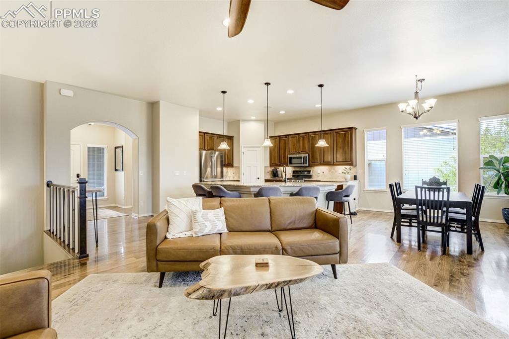 Image 11 of 48: Open-concept living space featuring hardwood flooring, recessed lighting, a