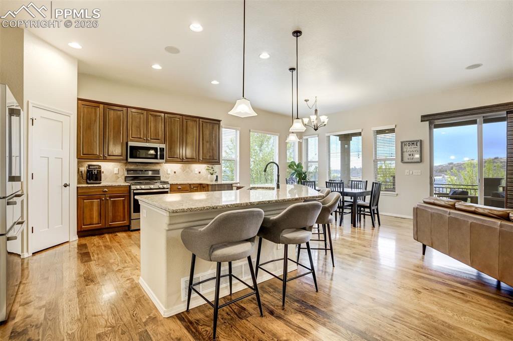 Image 13 of 48: Open-concept living space featuring hardwood flooring, recessed lighting, a
