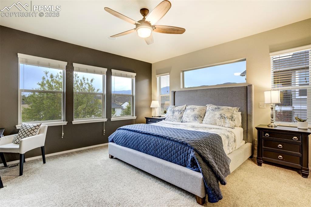 Image 25 of 48: Look at the views! Carpeted bedroom featuring a ceiling fan with integrated