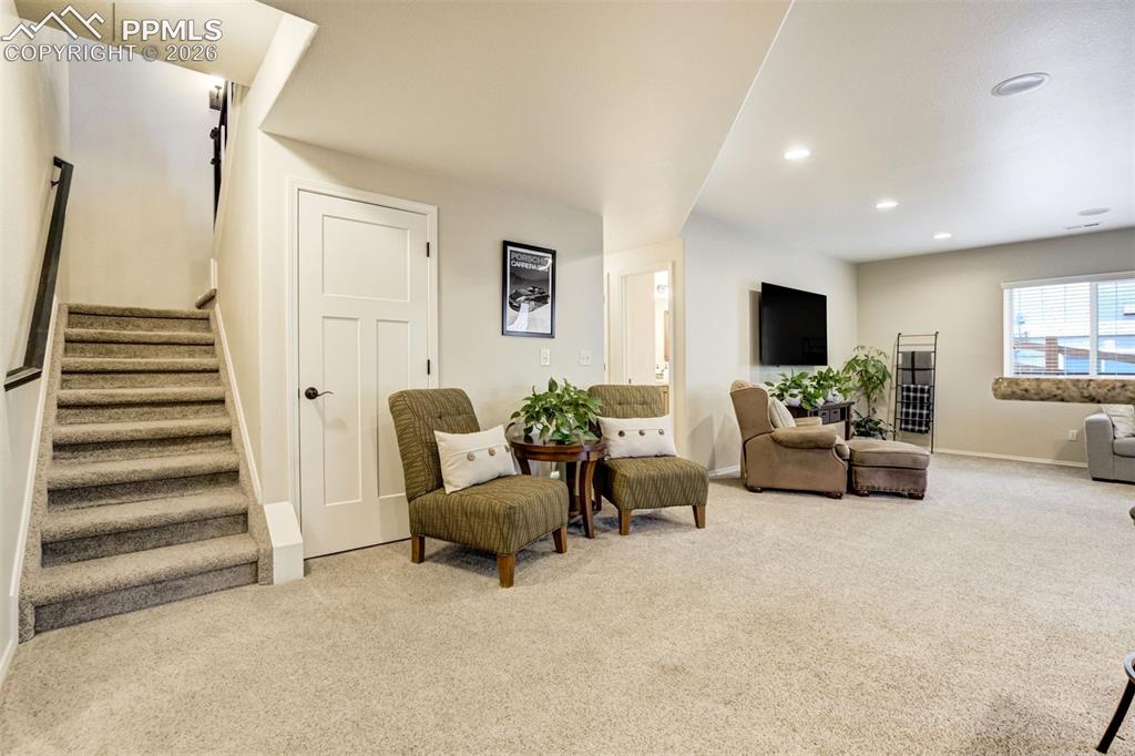 Image 32 of 48: Spacious carpeted room featuring recessed lighting, a window with blinds, a