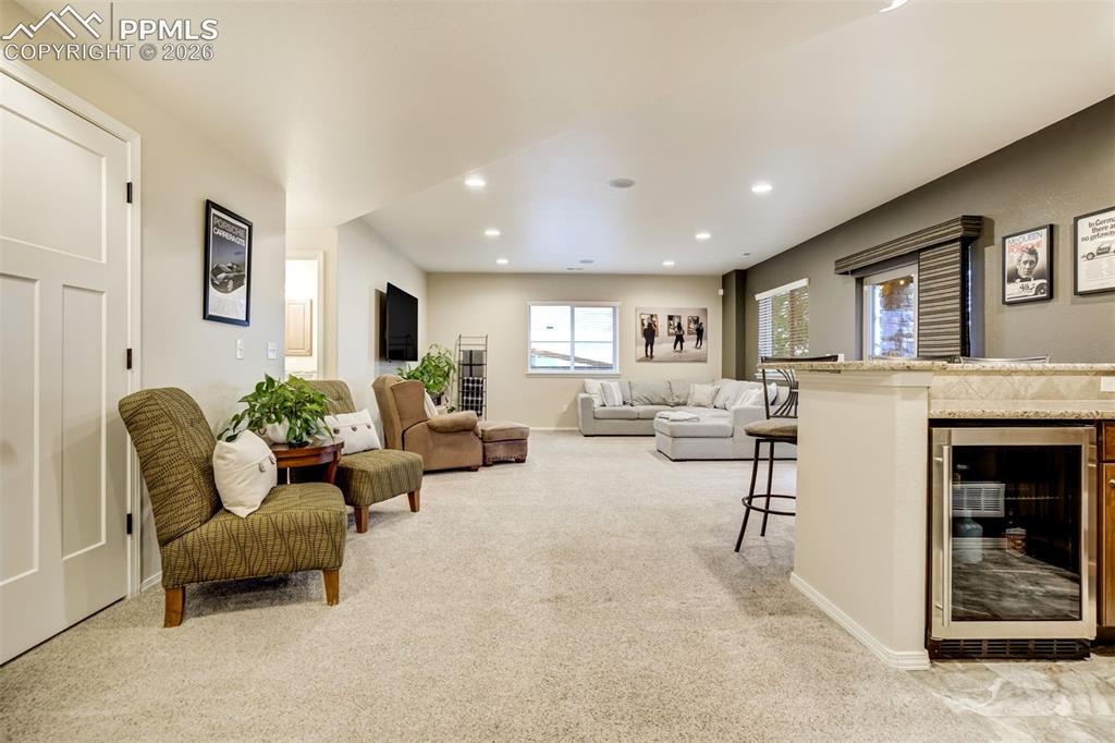 Image 33 of 48: Spacious entertainment area featuring recessed lighting, light-toned carpet