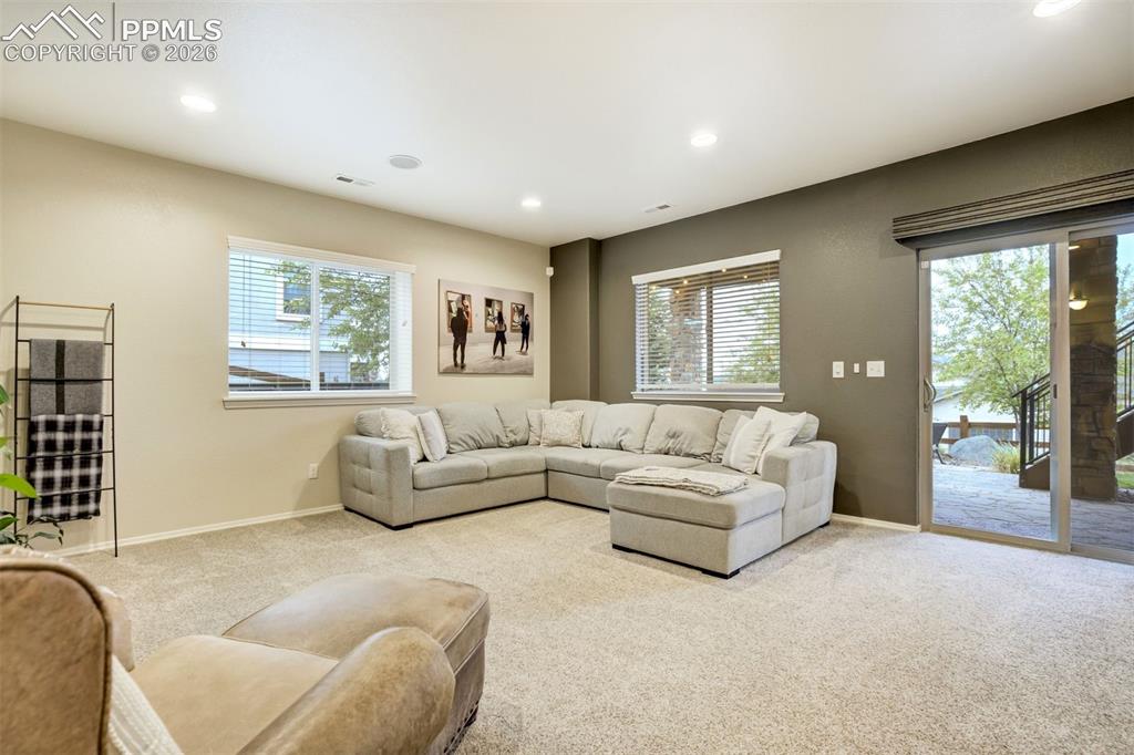 Image 37 of 48: Spacious interior room with light beige carpeting and recessed lighting